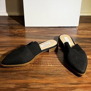 Black mule sandals with sock-like stretchy material.